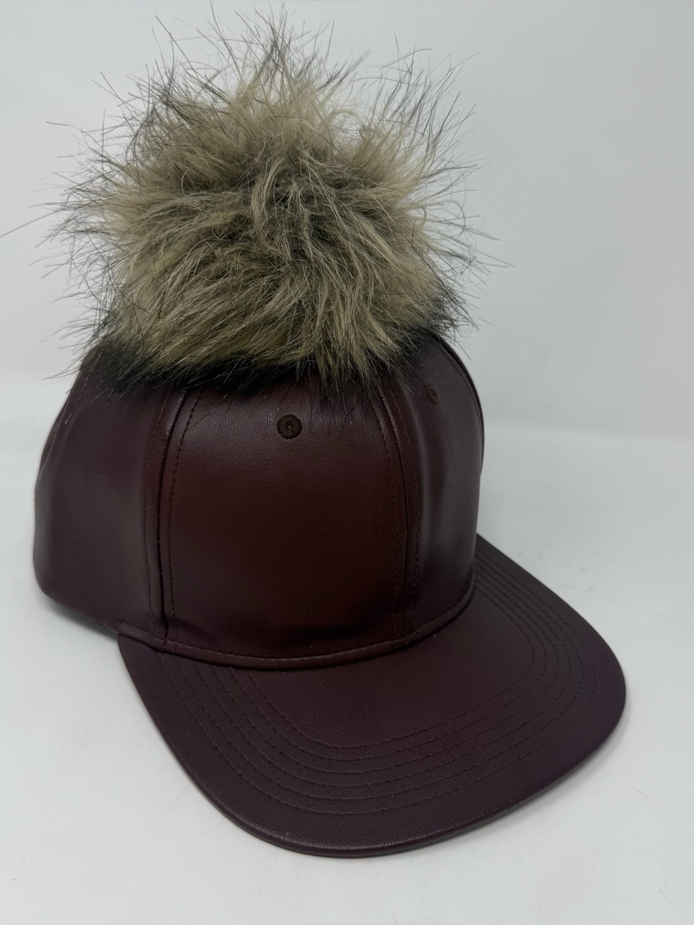 faux leather baseball cap by Premium Hatco features a faux fur pompom